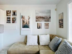 a living room with a couch and pictures on the wall at 2BR 1BA Guest Suite - Free Parking - Central Location w/ Mountain-View in Vancouver