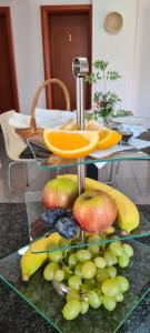 a display of fruit on a glass table at Rooms Stanic in Velika Gorica