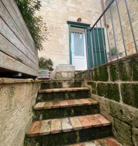 a set of stairs with a door and a window at Residence Le Vie Del Mosto in Matera