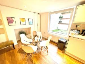 a dining room with a table and chairs and a window at HISTORICAL BUILDING / Cozy Basement Apt / Central in Cambridge