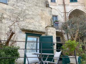 um grupo de cadeiras sentadas em frente a um edifício em Residence Le Vie Del Mosto em Matera