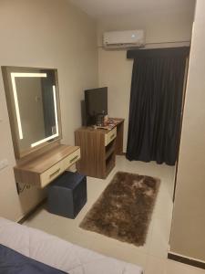 1 dormitorio con espejo, tocador y TV en AliBaba Pyramids View en El Cairo