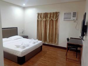 Tempat tidur dalam kamar di ASIA JEM HOTEL - GAPAN CITY