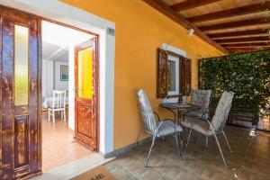 a dining room with chairs and a table and a door at Villa Lucky in Brtonigla