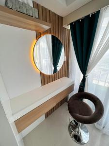 a mirror and a stool in a room with a window at Davao City Serenity on Seventeenth One-Bedroom Condo beside Shopping Malls with Seaview and City view in Davao City