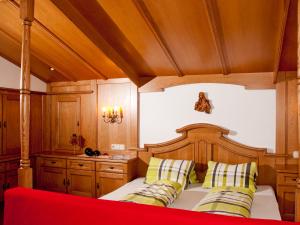a bedroom with a wooden bed with two pillows at Adlerhorst , Gstan 31 in Finkenberg
