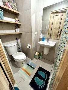 a bathroom with a toilet and a sink at 1BR Condo beside Abreeza Mall, Davao City with 200 mbps WI-FI speed in Davao City