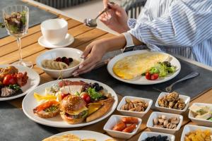 a table topped with plates of food and bowls of food at Europe Hotel Tashkent in Tashkent +93 photos