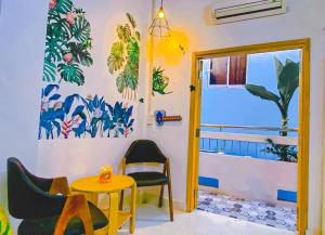 a room with chairs and a table and a window at Ngõ Saigon Homestay in Ho Chi Minh City