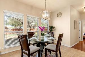 a dining room with a table and chairs and a chandelier at Sleep on the Cloud - 5 Bedrooms - Corner Lot in San Antonio