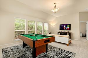 a living room with a pool table and a tv at Sleep on the Cloud - 5 Bedrooms - Corner Lot in San Antonio