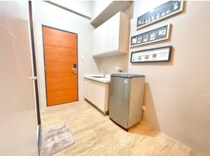 a small kitchen with a sink and a door at ADB TOWER in Manila