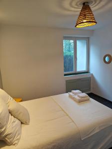 a bedroom with a large bed with two towels on it at Villa Delalo in Barcelonnette