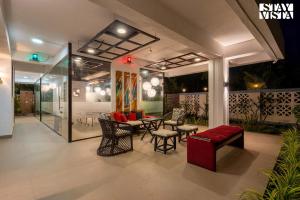 a living room with a table and chairs and a table and chairsktop at River Song by VEO - Part of StayVista in Lonavala