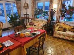 a living room with a table with food on it at le cardinal in Culoz