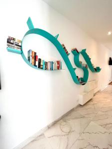 a wall with a sign that reads books at Bright Bookworm's Haven in Sliema