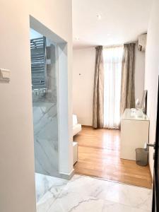 a bathroom with a glass shower in a room at Bright Bookworm's Haven in Sliema