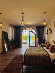 a bedroom with a bed and an open door at La Plage Classique Beachfront Nusa Penida in Nusa Penida