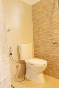 a bathroom with a white toilet and a shower at The villaRo in Hikkaduwa +42 photos