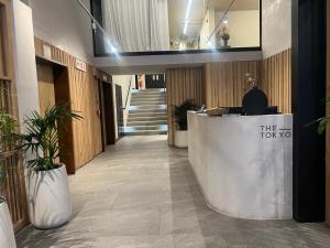 a lobby with a reception desk in a building at The Tokyo 708 - Family Studio in Cape Town