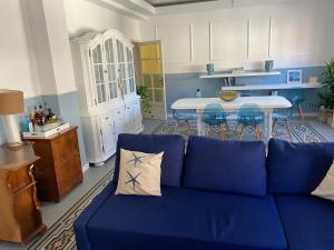 Sofá azul en la sala de estar con mesa en Amor blue -Relax and Beach, en Marina di Carrara