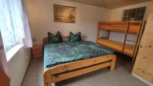 a bedroom with a bed and a bunk bed at Ferienwohnung Lang in Breitenbrunn
