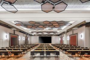 a large room with tables and chairs in it at M Social Hotel Suzhou in Suzhou