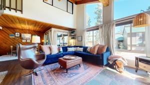 a living room with a blue couch and a chair at Courchevel #5 condo in Mammoth Lakes