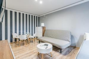 a small room with a bed and a table at Apartament Black Stripes blisko morza in Gdańsk