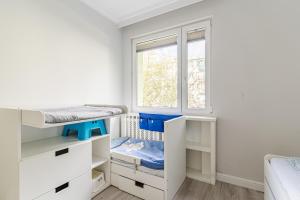 a room with two bunk beds and a window at Black Chairs - Apartament blisko morza in Gdańsk
