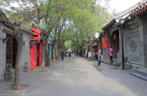 a street in an asian city with people walking down a street at Happy Dragon Hotel - close to Forbidden City&Wangfujing Street&free coffee &English speaking,Newly renovated with tour service in Beijing