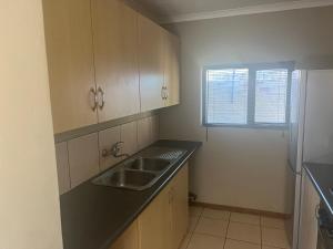 a small kitchen with a sink and a window at The small-haven in Polokwane