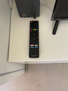 a remote control sitting on top of a table at Canberra Hospital Locum Welcome in Harman
