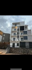 um grande edifício branco com uma escada em frente em Kigali Swift Rentals em Kigali