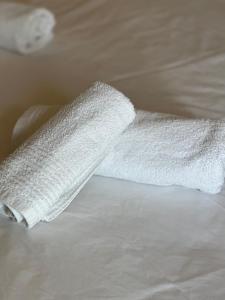 a white towel laying on top of a bed at Casa romantica de luxe in Campobasso