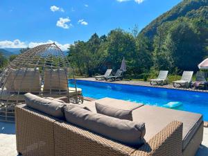a swimming pool with a couch and a bird cage at Garemo in Ambrolauri