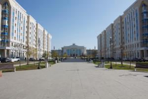 a street in a city with buildings and benches at Новая квартира в ЖК "Millennium Park" in Promyshlennyy