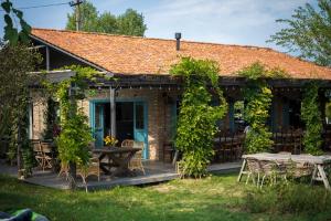 a cottage with a table and chairs on a deck at 7 Lakes in Telavi