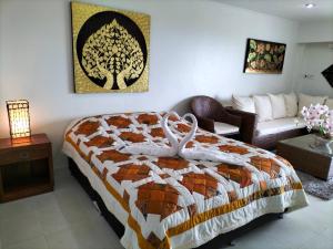 a bedroom with a bed and a living room with a couch at Sea Sand Sun Resort in Ban Phe