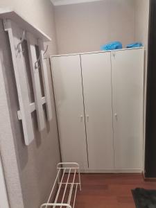 a room with two white cabinets and a mirror at Однокомнатная квартира-студия в Гагре! Море солнца in Gagra