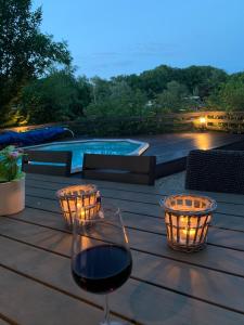 a glass of wine sitting on a wooden table at Holiday Home 'Beautifull Water' in Lanaken