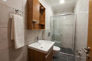 a bathroom with a sink and a shower and a toilet at Park Çağlayan Hotel in Istanbul