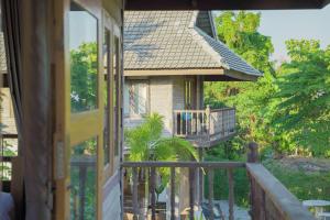 a porch of a house with a balcony at baanchandra in Chiang Mai