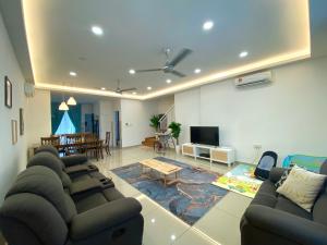a living room with couches and a dining room at Little Boo Homestay @ Kota Warisan in Sepang