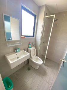 a bathroom with a toilet and a sink and a shower at Little Boo Homestay @ Kota Warisan in Sepang +7 photos
