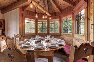 a dining room with a table in a wooden house at Chalet les Bubus in La Tzoumaz