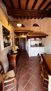 a living room with a table and chairs and a table and a tablektopktop at Locanda Il Sigillo B&B e Ristorante in Rosignano Marittimo