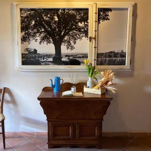 a table with a mirror and a tree in the window at Locanda Il Sigillo B&B e Ristorante in Rosignano Marittimo +54 photos