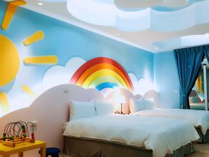 - une chambre avec une fresque arc-en-ciel et 2 lits dans l'établissement Seed House, à Taïtung