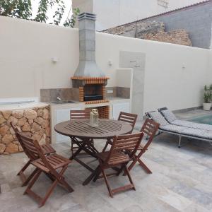 une terrasse avec une table, des chaises et une cuisinière dans l'établissement La Casica, à Benijófar